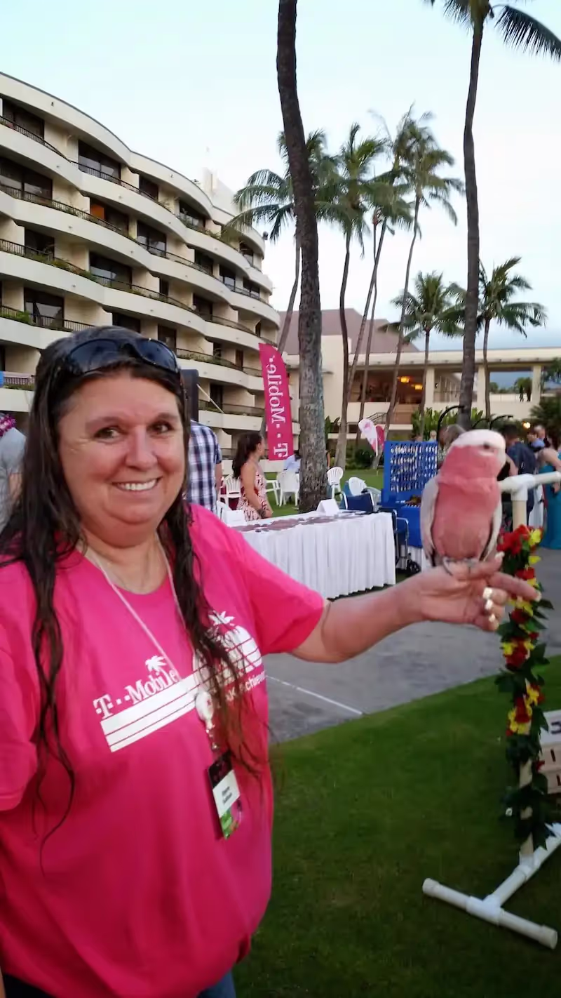 Joyce holding a bird at T-Mobile event.