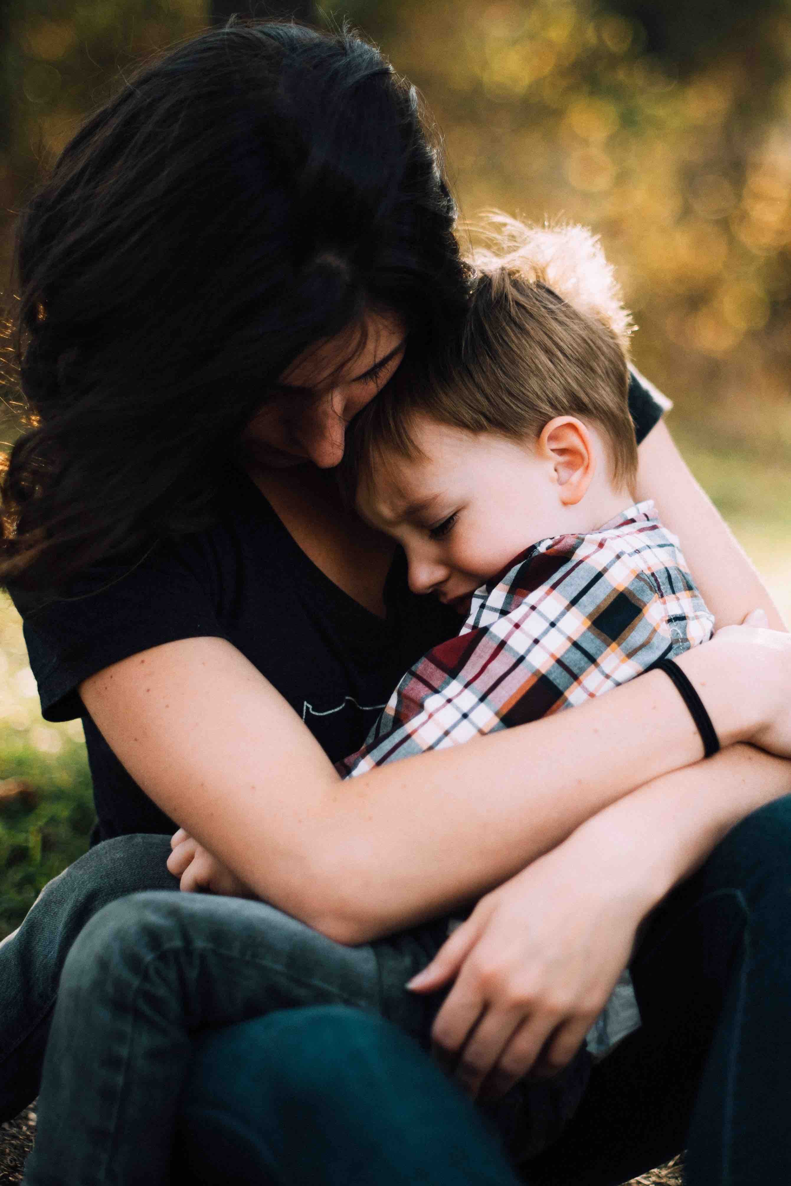 mother consoles young son