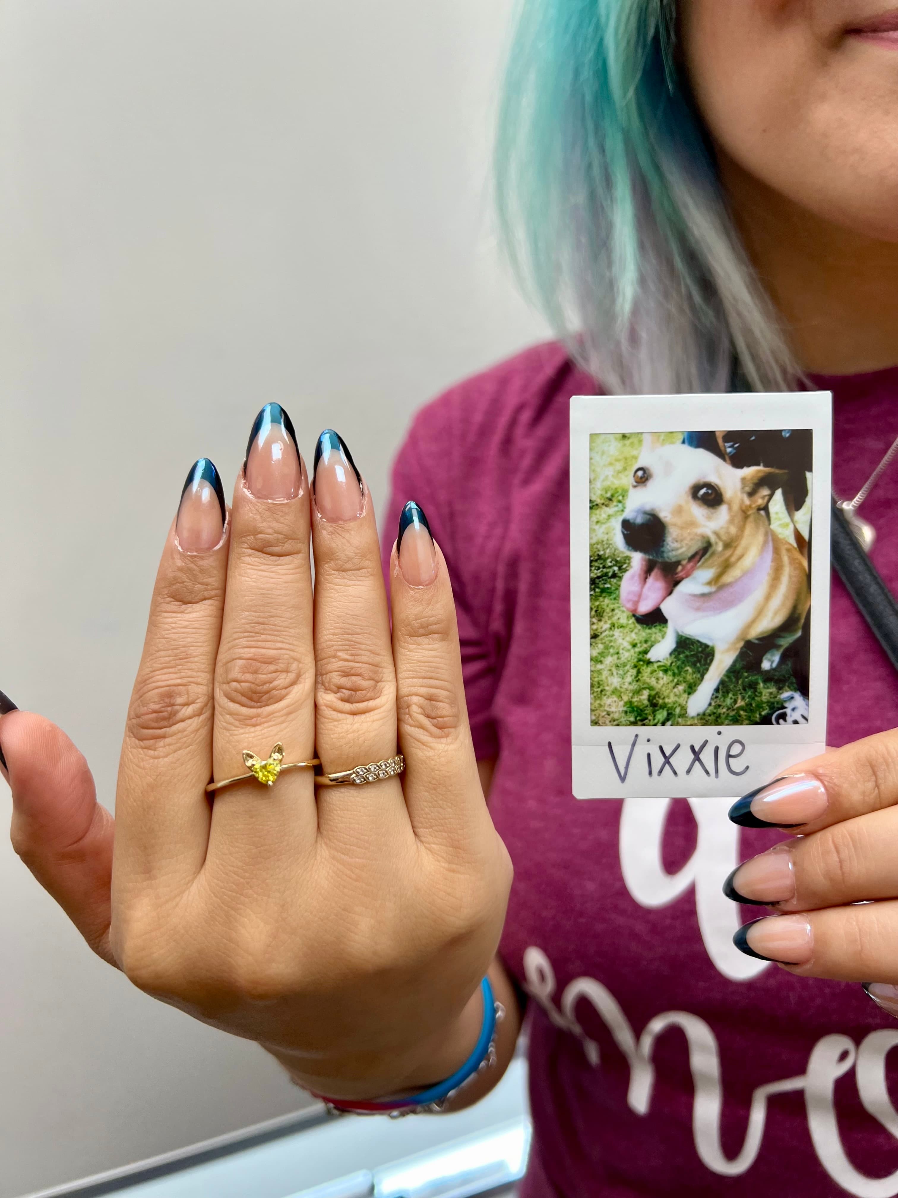 woman shows yellow diamond made from dog's ashes