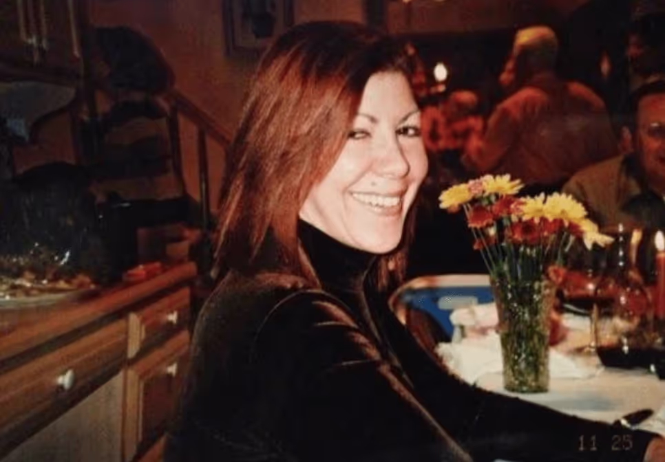 Tracey smiling at a dinner table.