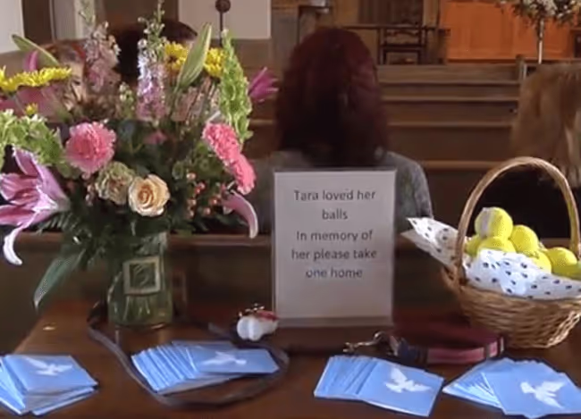Giving away keepsakes at dogs memorial service.