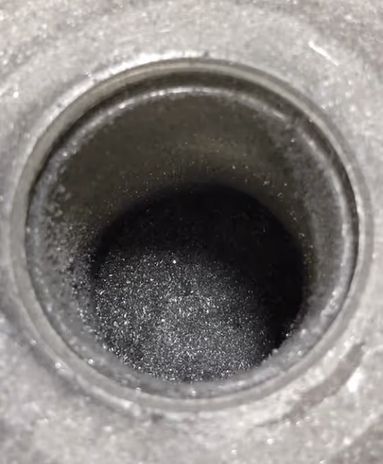 Carbon powder, in the form of graphite, in a crucible.